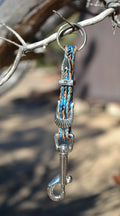 Close Up View Handmade natural horsehair braided key chain with silver tone faux buckle and snap. This key chain is about 6" long including the 1" key ring loop to connect the keys.   Sorrel/Turquoise/Black