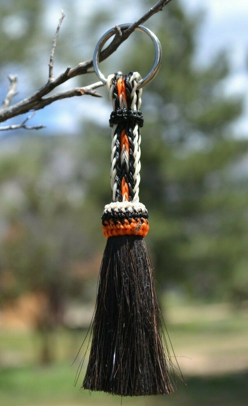 Close Up View 3/8" wide, 3 Strand Braided Horsehair Key Chain. This shorter style is 5 1/2" including the key ring.     White/Orange/Black