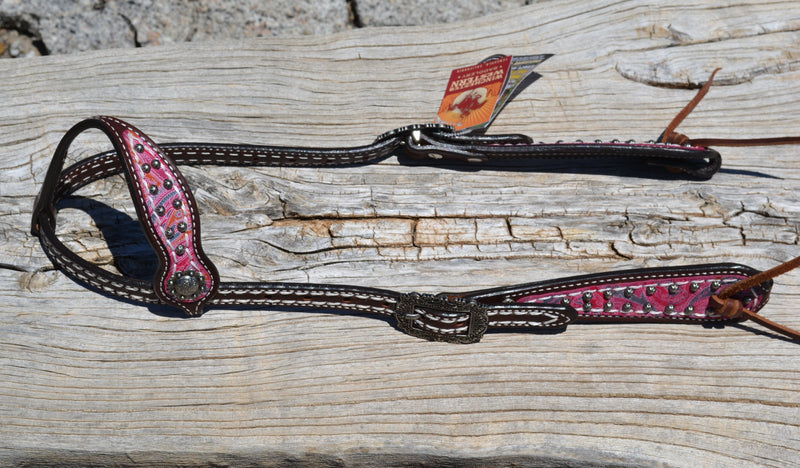Vintage Paisley One Ear Headstall.  Made from dark brown leather heavy denim style wheat colored stitching.  Part of the Weaver Vintage Paisley Collection.   Cheek and ear piece have a pink and orange overlay with small antiqued studs.  Tumbled leather ties at the bit ends.  Vintage style buckles are adjustable on both sides.
