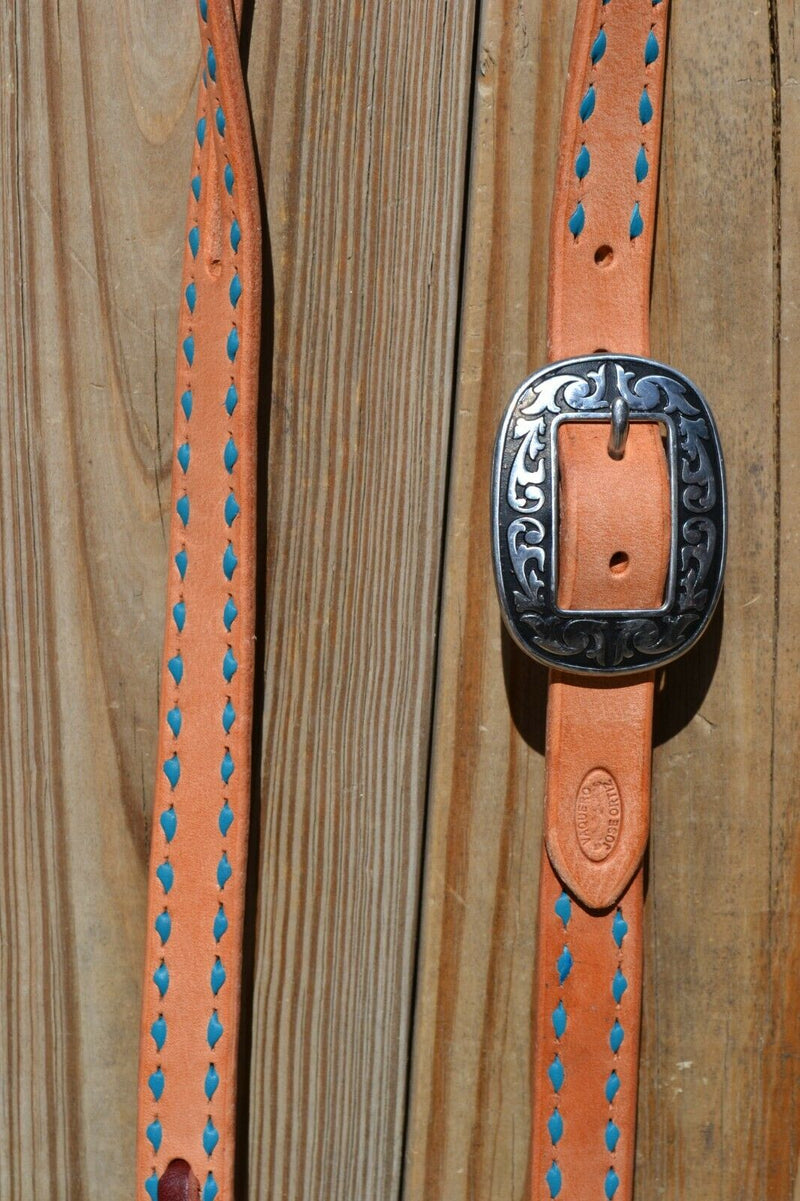 Close Up Antiqued Buckle. Jose Ortiz 1" One/Single Split Ear Headstall.  Constructed of single-ply natural harness leather with turquoise blue leather buckstitched by hand. 