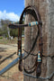 Jose Ortiz 5/8" Shape Browband Headstall.  Constructed of two-ply and stitched dark chocolate oil  finished leather.  Hand carved with Jose's signature basket weave tooling and natural hand braided rawhide with turquoise details on cheek pieces and browband