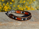 Close Up View Awesome 3/8" wide, 3 Strand Braided Horsehair Bracelet with a lobster claw clasp and various colored and patterned bone beads. Chestnut/Black/Silver