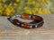 Close Up View Awesome 3/8" wide, 3 Strand Braided Horsehair Bracelet with a lobster claw clasp and various colored and patterned bone beads. Chestnut/Black/Silver