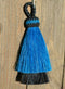 Close Up View 3" two Bell mule tail cut natural and brightly colored tassels. Handmade from horsehair dyed in bright colors as well as natural.    Turquoise/Black