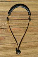 1/4" hand braided dark natural rawhide pencil bosal with a rawhide core and black calf leather nose and knot with tan details.  Noseband measures 1/2" wide at the thickest point. 