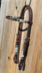 Jose Ortiz 5/8" Straight Browband Headstall.  Constructed of two-ply and stitched dark chocolate oil  finished leather.  Hand carved with Jose's signature basket weave tooling and natural hand braided rawhide with turquoise details on cheek pieces and browband.
