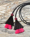 Close Up View natural horse hair Stampede String with two bell mule tail cut tassels and cotter pin attachments. Black/Black/Pink