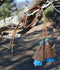 Close Up View  natural horse hair Stampede String with two bell mule tail cut tassels and cotter pin attachments.    Chestnut/Chestnut/Turquoise
