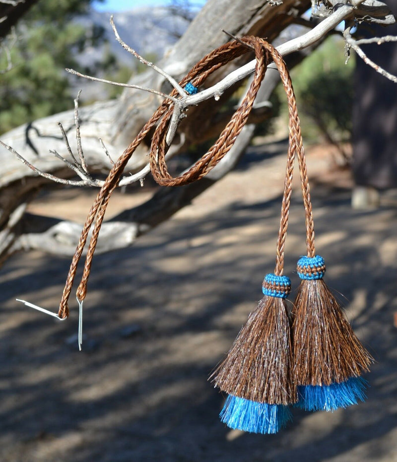 Close Up View  natural horse hair Stampede String with two bell mule tail cut tassels and cotter pin attachments.    Chestnut/Chestnut/Turquoise