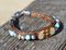 Close Up View Awesome 3/8" wide, 3 Strand Braided Horsehair Bracelet with a lobster claw clasp and various colored and patterned bone beads. Sorrel/Turquoise