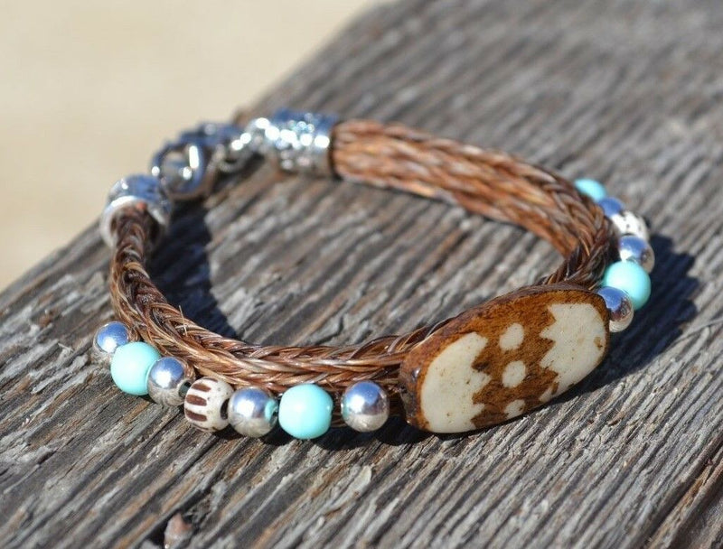 Close Up View Awesome 3/8" wide, 3 Strand Braided Horsehair Bracelet with a lobster claw clasp and various colored and patterned bone beads. Sorrel/Turquoise