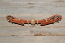 Handmade 1/2" conditioned harness leather curb strap with tightly braided natural rawhide rings and 1" center knot.  Conditioned leather has that already broken in feel.