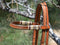 Close Up View Jose Ortiz 5/8" Straight Browband Headstall.  Constructed of two-ply and stitched russet oil  finished leather.  Hand carved with Jose's signature basket weave tooling and natural hand braided rawhide with latigo brown details on cheek pieces and browband.  