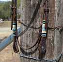 Jose Ortiz 5/8" Shape Browband Headstall.  Constructed of two-ply and stitched dark chocolate oil  finished leather.  Hand carved with Jose's signature basket weave tooling and natural hand braided rawhide with turquoise details on cheek pieces and browband