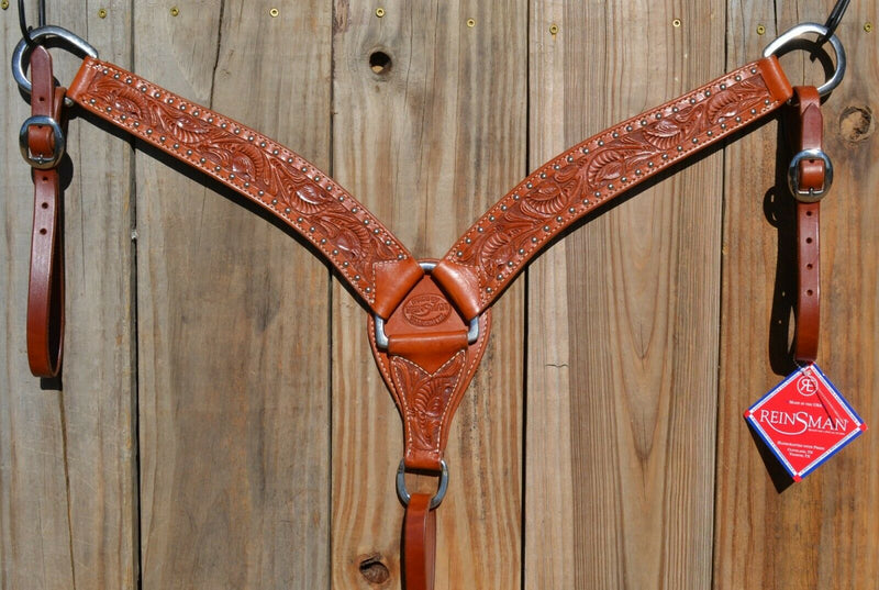 Reinsman Heavy Duty 2" Double Ply Leather Breast Collar with Hand Carved Arizona Flower tooling with spots.  Warm light mahogany color leather.  Stainless steel hardware and tugs and cinch drop.   1" x 12" adjustable tugs. 