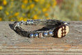 Close Up View Awesome 3/8" wide, 3 Strand Braided Horsehair Bracelet with a lobster claw clasp and various colored and patterned bone beads. Grey/Silver