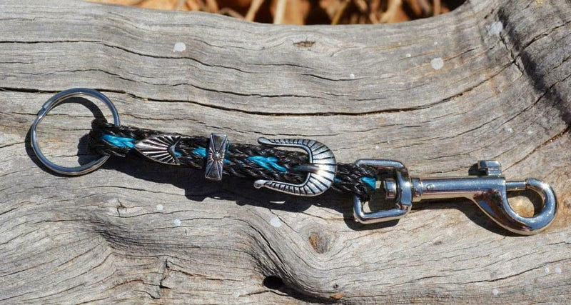Close Up View Handmade natural horsehair braided key chain with silver tone faux buckle and snap. This key chain is about 6" long including the 1" key ring loop to connect the keys.    Black/Turquoise
