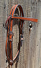 Right Side View Classic Straight Flared Browband Headstall. Constructed of warm two-ply and stitched medium russet oil bridle leather with basket weave tooling on the flared cowboy cheek pieces. 