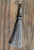 Close Up View 4 1/2" total length horsehair zipper pull with spring clip. Handmade horsehair various colors and beading pattern. Grey-Gold/Silver/Gold