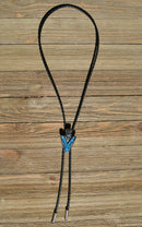 Western Style Black Braided Leather Bolo Tie with beautifully detailed arrow head slide in silver and matt black and turquoise southwest enamel design.  Bolo has silver colored tips. 