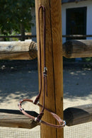Jose Ortiz has made these beautiful rolled harness leather adjustable western training cavesons with latigo hangers.   Made from beautifully conditioned Hermann Oak harness leather with 3 natural rawhide knots with burgundy latigo details over the nose and natural rawhide hanger knots.  