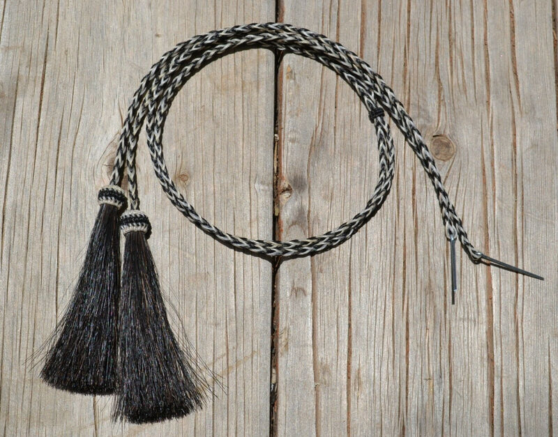 Close Up View natural horse hair stampede string with cotter pin attachments.     Black/White/Black