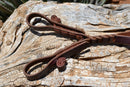 Detail View Jose Ortiz handmade 1/2" latigo leather long tassel curb strap.  Tassel is 6" in length and attaches with self-tie bit attachments. 