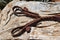 Detail View Jose Ortiz handmade 1/2" latigo leather long tassel curb strap.  Tassel is 6" in length and attaches with self-tie bit attachments. 