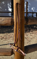 Jose Ortiz has made these beautiful rolled harness leather adjustable western training cavesons with latigo hangers.   Made from beautifully conditioned Hermann Oak harness leather with 3 natural and black and natural rawhide knots over the nose and natural rawhide hanger knots. 