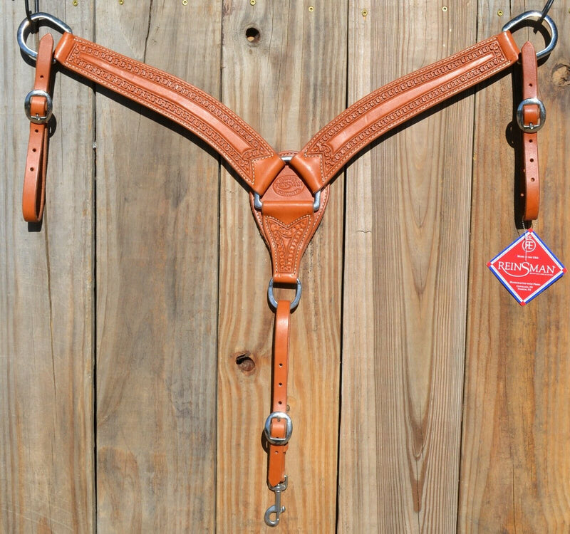 Reinsman Heavy Duty 2" Double Ply Leather Breast Collar with Hand Carved with Snake border tooling.  Light honey color leather.  Stainless steel hardware and tugs and cinch drop.   1" x 12" adjustable tugs. 