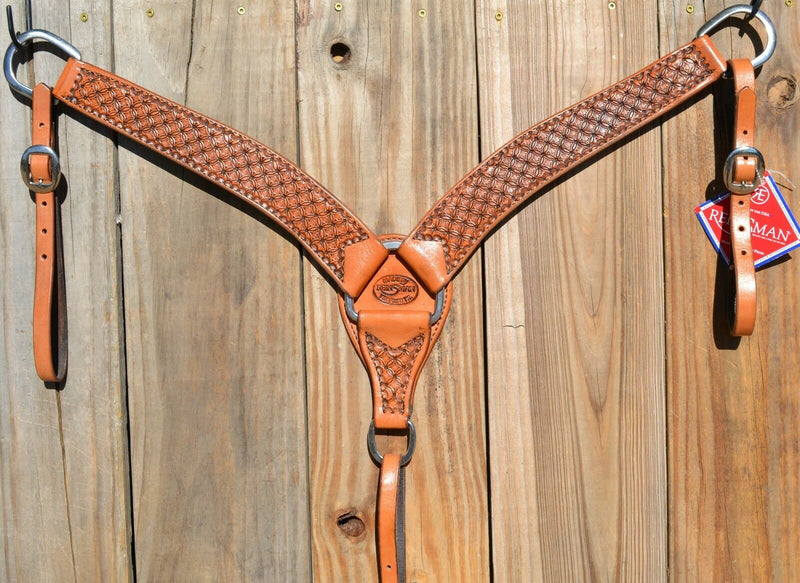 Reinsman Heavy Duty 2" Double Ply Contoured Breast Collar with Hand Carved with Waffle Box Tooling.    Stainless steel hardware and tugs.   1" x 12" adjustable elastic tugs.   Old West antiqued wash color.