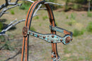 Close Up View Circle Y of Yoakum -  Custom 5/8" Scalloped Browband Gag Headstall  with floral tooling with antiqued wash on crown.   Browband and cheek pieces have turquoise faux gator overlay accented with antiqued parachute spots.   Antiqued copper conchos on browband and bit ends. 