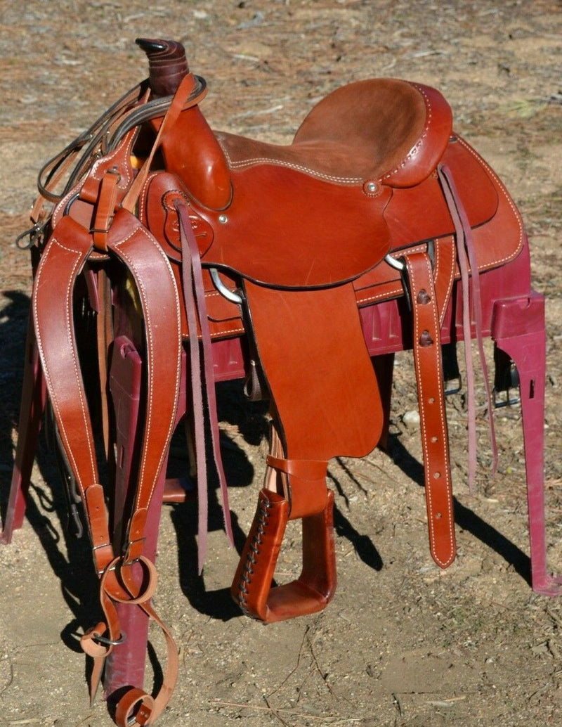 16" Dakota Roping Saddle with tan suede seat.   Includes flank set, martingale style breast collar, plain headstall and reins.  Full set ready to ride.  Smooth finish medium oil.  Square skirts.  