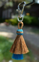 Close Up View 4.25" total length natural horsehair zipper pull with Larger Clasp. Handmade horsehair in the two bell mule tail style.     Chestnut/Turquoise