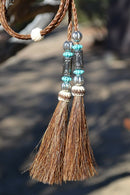 Super Close Up Detail View natural horse hair Stampede String with beads and horse hair tassels and cotter pin attachments.  Chestnut- Turquoise/Silver/Turquoise