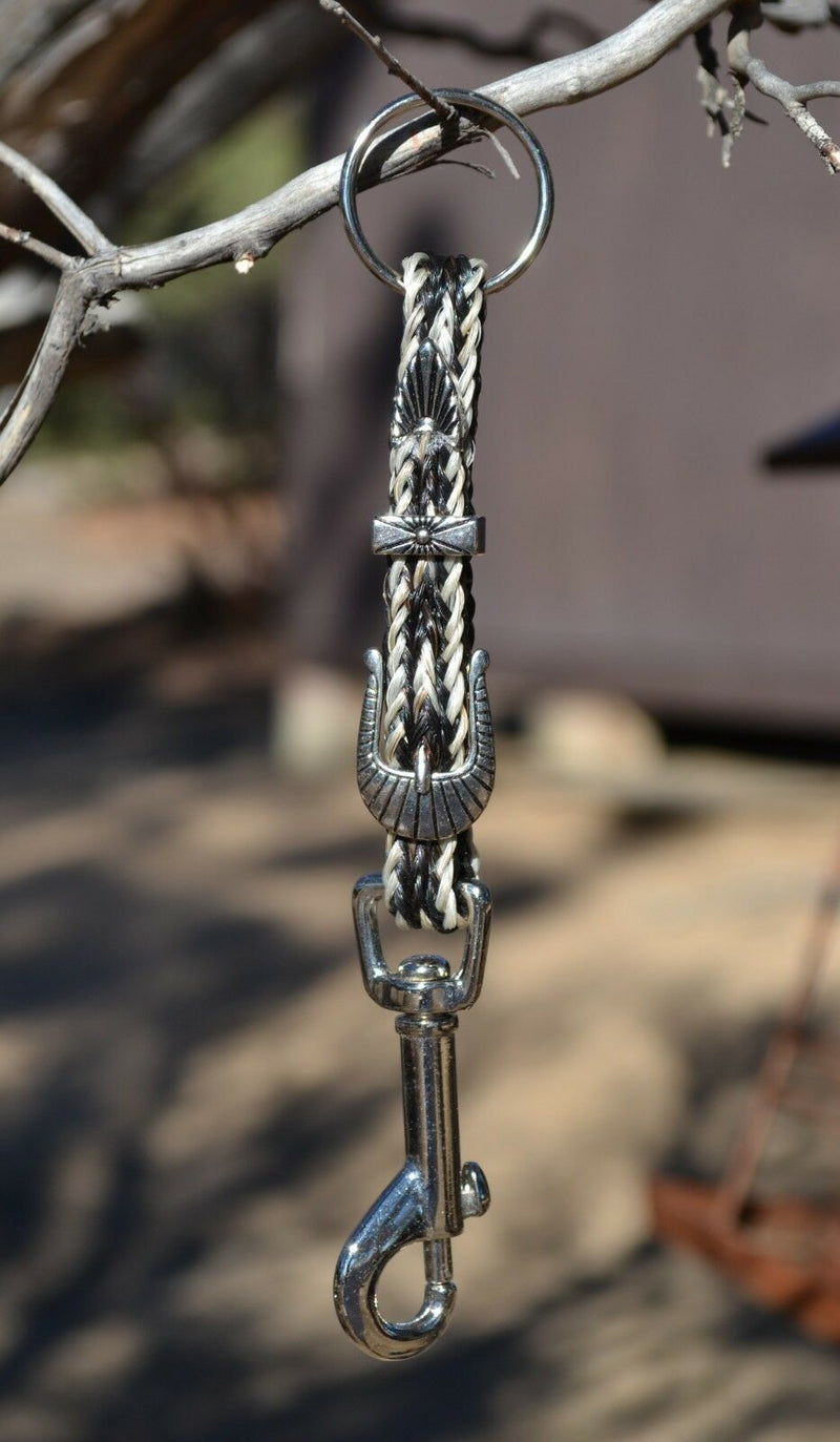 Close Up View Handmade natural horsehair braided key chain with silver tone faux buckle and snap. This key chain is about 6" long including the 1" key ring loop to connect the keys.    White/Black/White