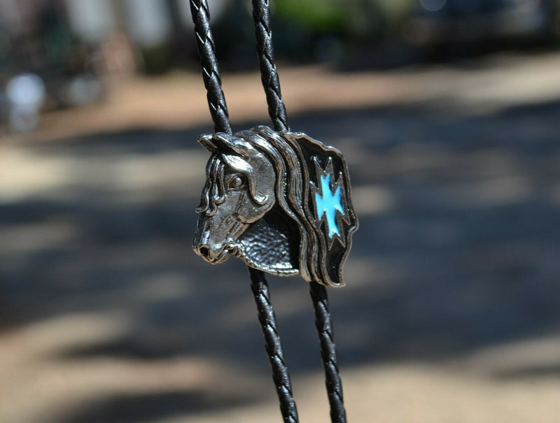 Super Close Up View Western Style Black Braided Leather Bolo Tie with beautifully detailed horse head slide in silver with black and turquoise southwest enamel design. 