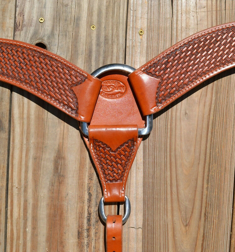 Close Up View Reinsman Heavy Duty 2 3/4" Double Ply Leather Breast Collar with Hand Carved with mini basket weave tooling.  Reinsman's "Old West"  color leather.  Stainless steel hardware and tugs and cinch drop.   1" x 12" adjustable tugs. 