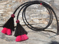 Close Up View natural horse hair Stampede String with two bell mule tail cut tassels and cotter pin attachments.  Black/Black/Pink