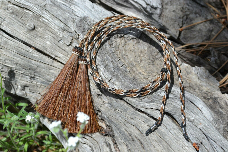 Close Up View Western Style 1/4" wide and 24" long, braided horse hair eye glass holder (gator/leash) with tassels.     Chestnut/Black/White