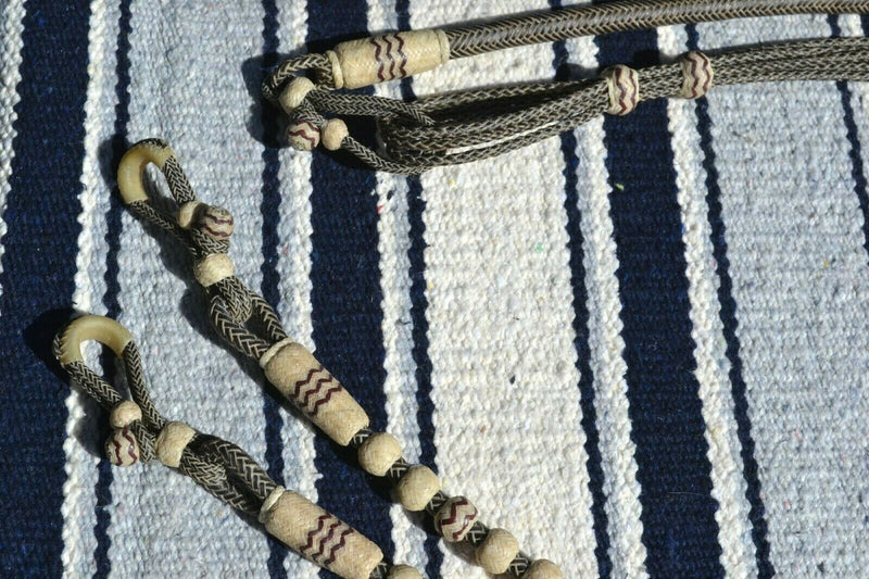 Close Up View Beautiful Jose Ortiz Romel Reins, 18 plait Hand Braided Brown Beveled Rawhide braided in the 3 strand Santa Ynex style with round knots and long buttons. 