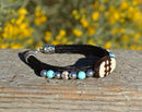 Close Up View Awesome 3/8" wide, 3 Strand Braided Horsehair Bracelet with a lobster claw clasp and various colored and patterned bone beads. Black/Turquoise