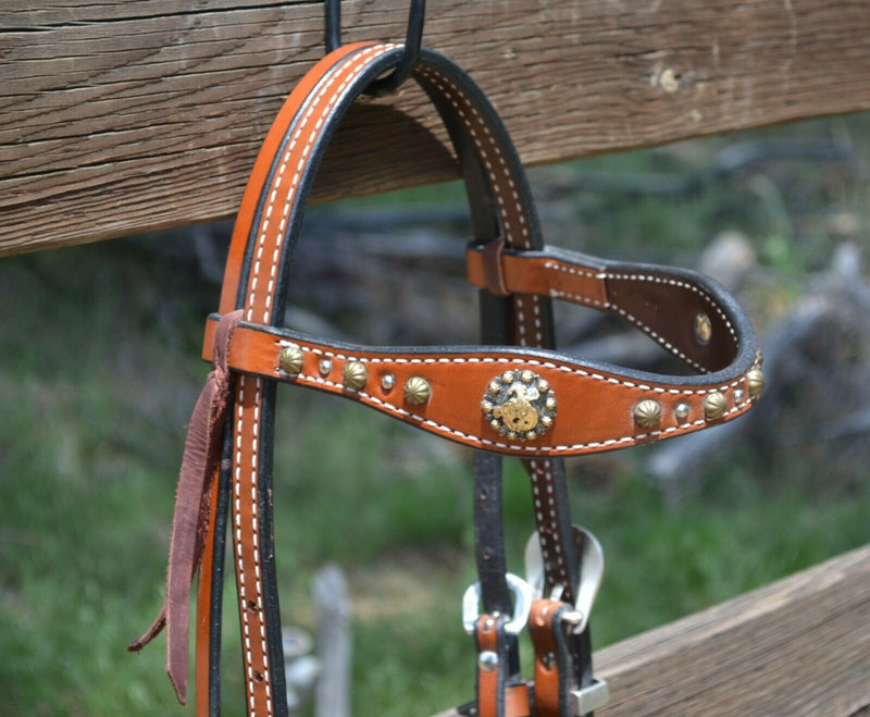 Close Up View  Regular oil, 5/8" Molly Powell Vintage Cowgirl Browband Headstall with spots and bucking cowboy berry conchos. 