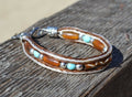 Close Up View Awesome 3/8" wide, 3 Strand Braided Horsehair Bracelet with a lobster claw clasp and various colored and patterned bone beads. White/Chestnut/Turquoise