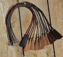 Close Up View Various Colors natural horse hair stampede string with cotter pin attachments. 