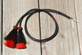 Close Up View natural horse hair Stampede String with two bell mule tail cut tassels and cotter pin attachments.    Black/Red