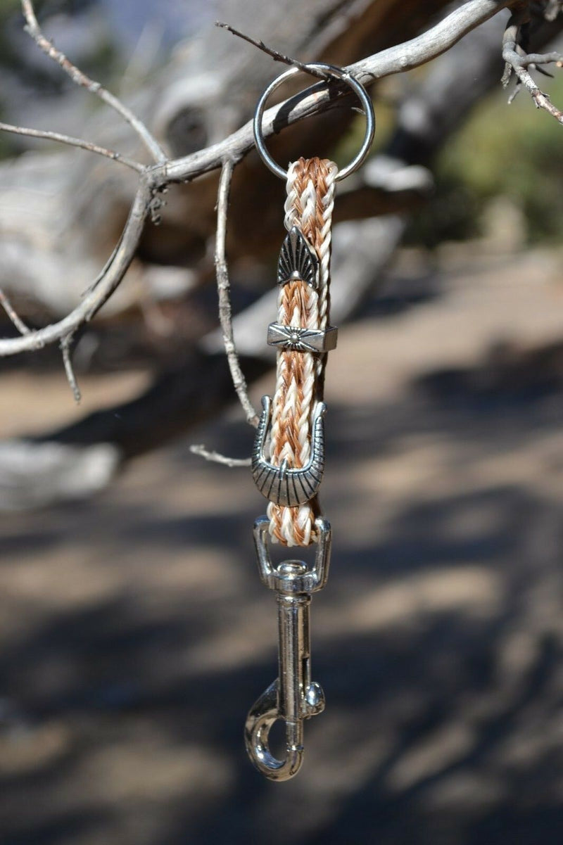 Close Up View Handmade natural horsehair braided key chain with silver tone faux buckle and snap. This key chain is about 6" long including the 1" key ring loop to connect the keys.    White/Sorrel/White