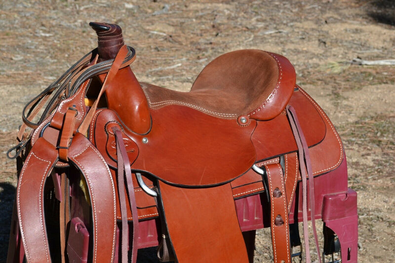 16" Dakota Roping Saddle with tan suede seat.   Includes flank set, martingale style breast collar, plain headstall and reins.  Full set ready to ride.  Smooth finish medium oil.  Square skirts.  