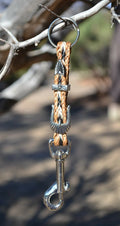 Close Up View Handmade natural horsehair braided key chain with silver tone faux buckle and snap. This key chain is about 6" long including the 1" key ring loop to connect the keys.   Sorrel/Black/White