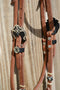 Close Up View Jose Ortiz 5/8" Shape Browband Headstall.  Constructed of super soft conditioned natural harness leather.  Jose's signature natural hand braided rawhide with black details on cheek pieces and browband.